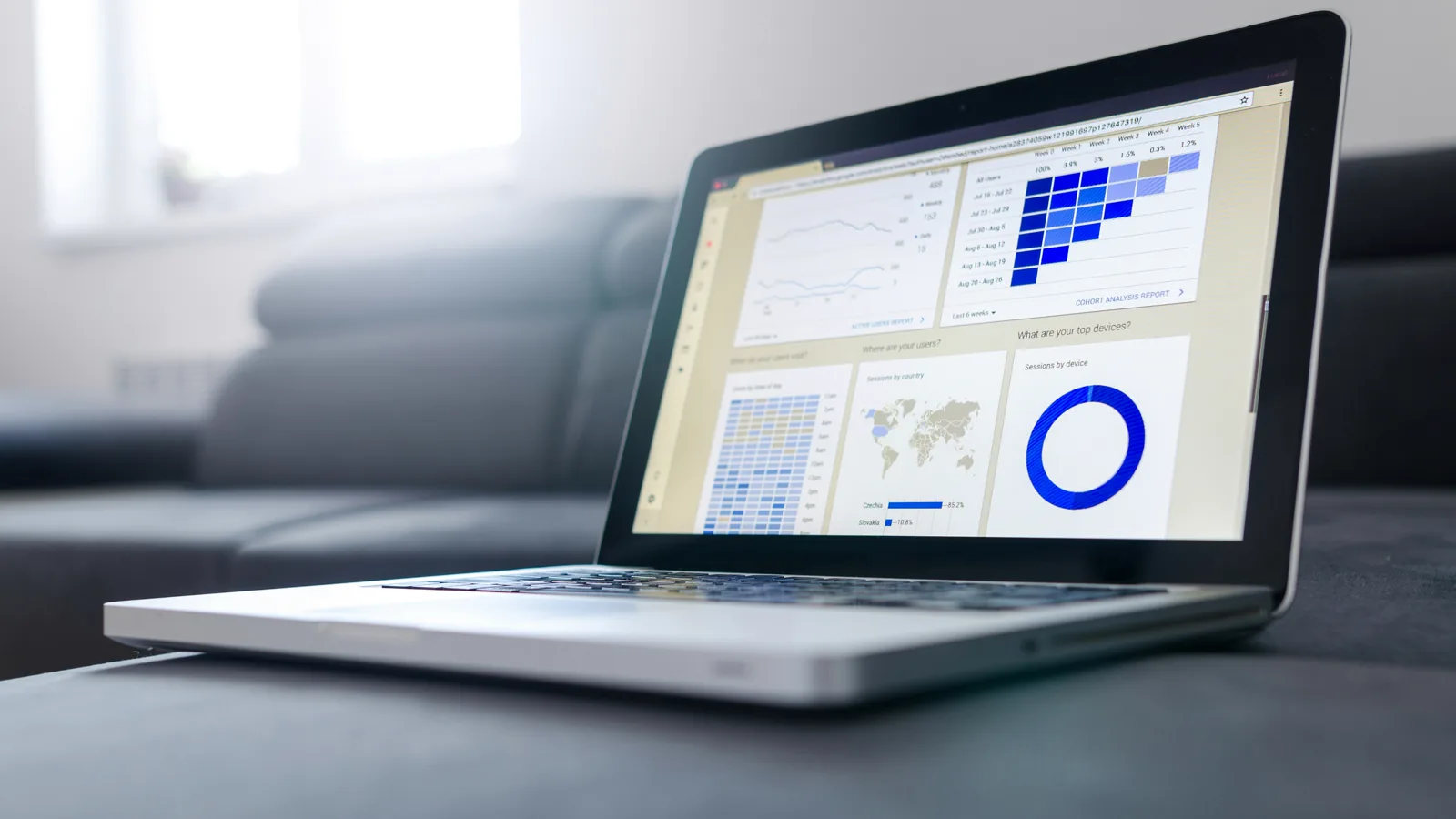 Laptop showing financial statistics and spreadsheets representing UAE bookkeeping and record-keeping