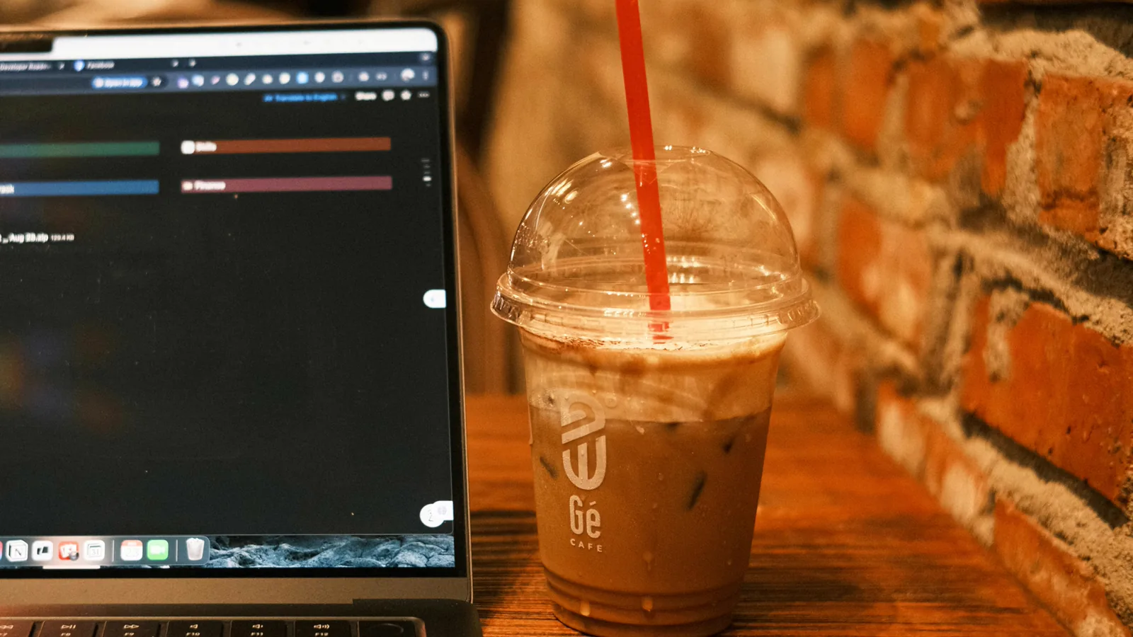 Laptop and coffee on a table representing a UAE freelancer working and managing tax