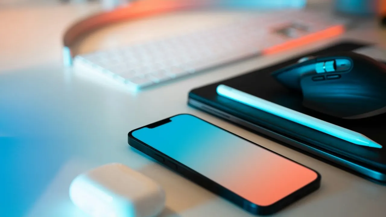 A work phone, keyboard and mouse on an office desk